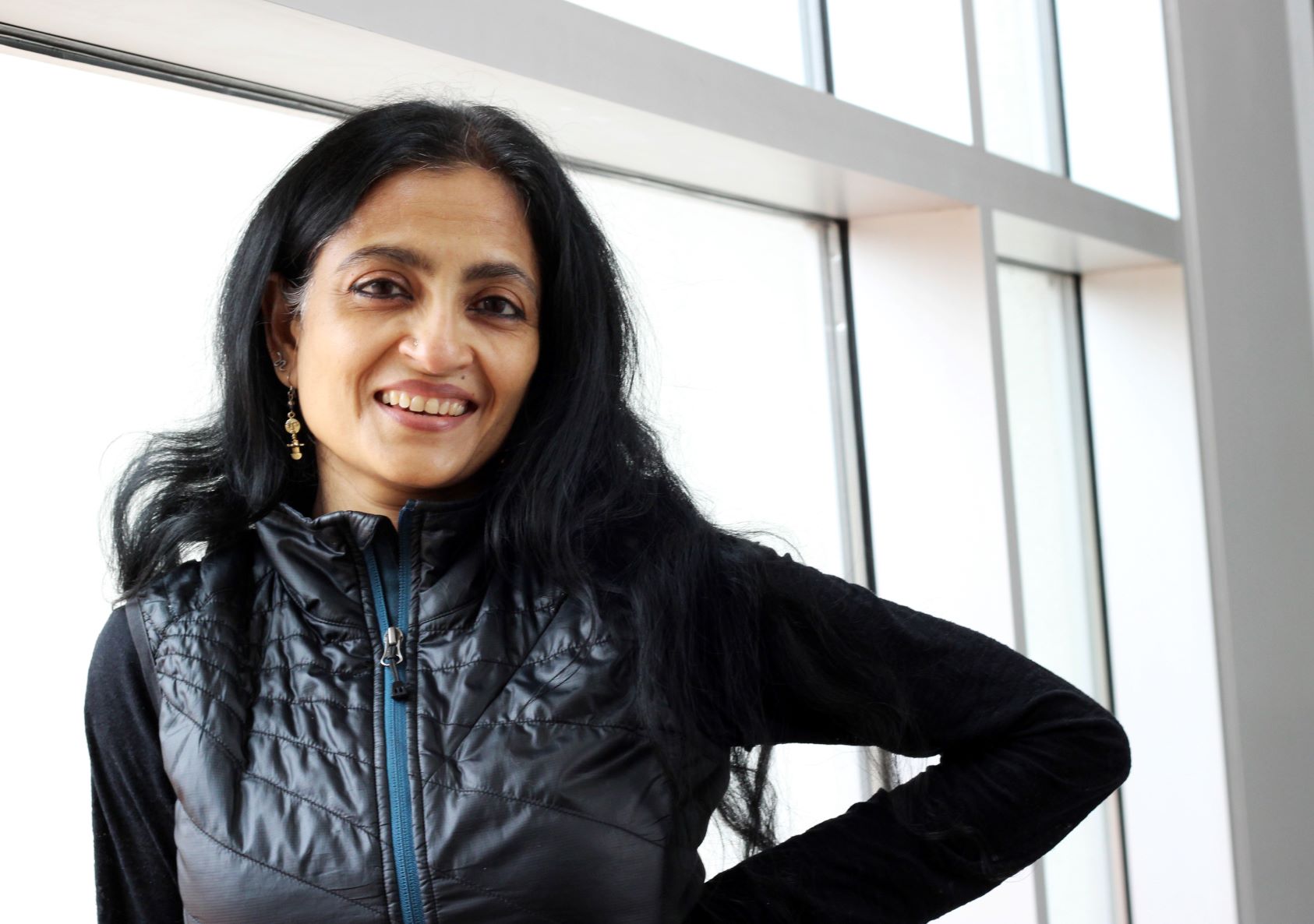 Woman against white background wearing black attire