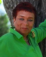 Woman in green blouse looks at camera