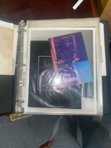 A binder page with two photographs inside